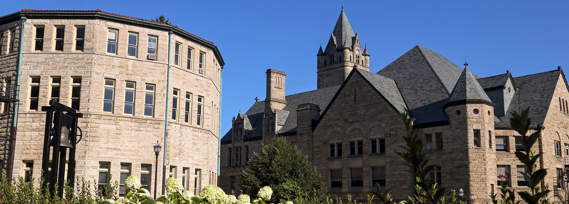 Sunny view on campus with Slocum Hall on the left and University Hall on the right